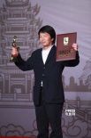 刘震云两颊绯红亮相后台 高举奖杯“要保持”